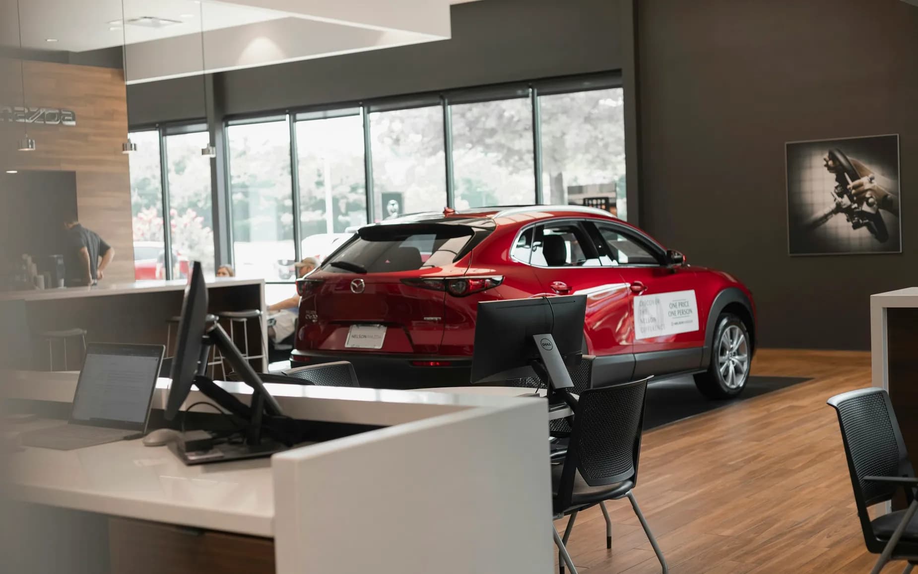 A dealership showroom with customer using Purple WiFi