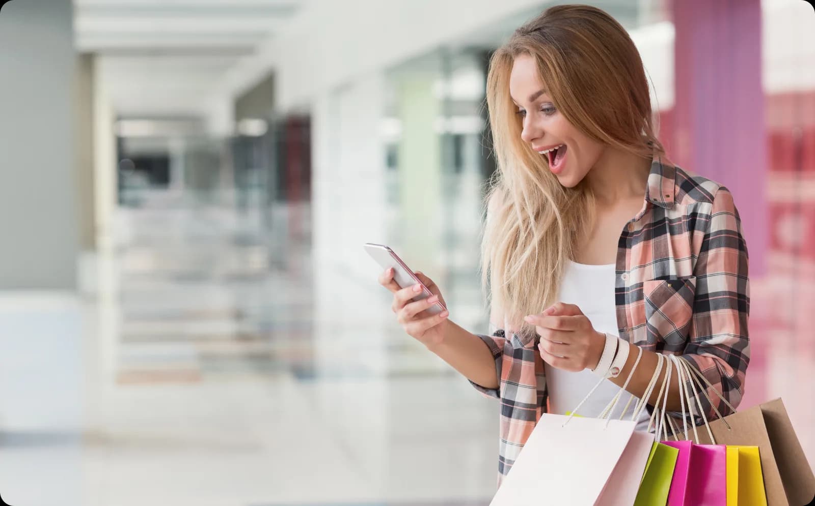 A shopper checking her phone on venue WiFi her device joined automatically