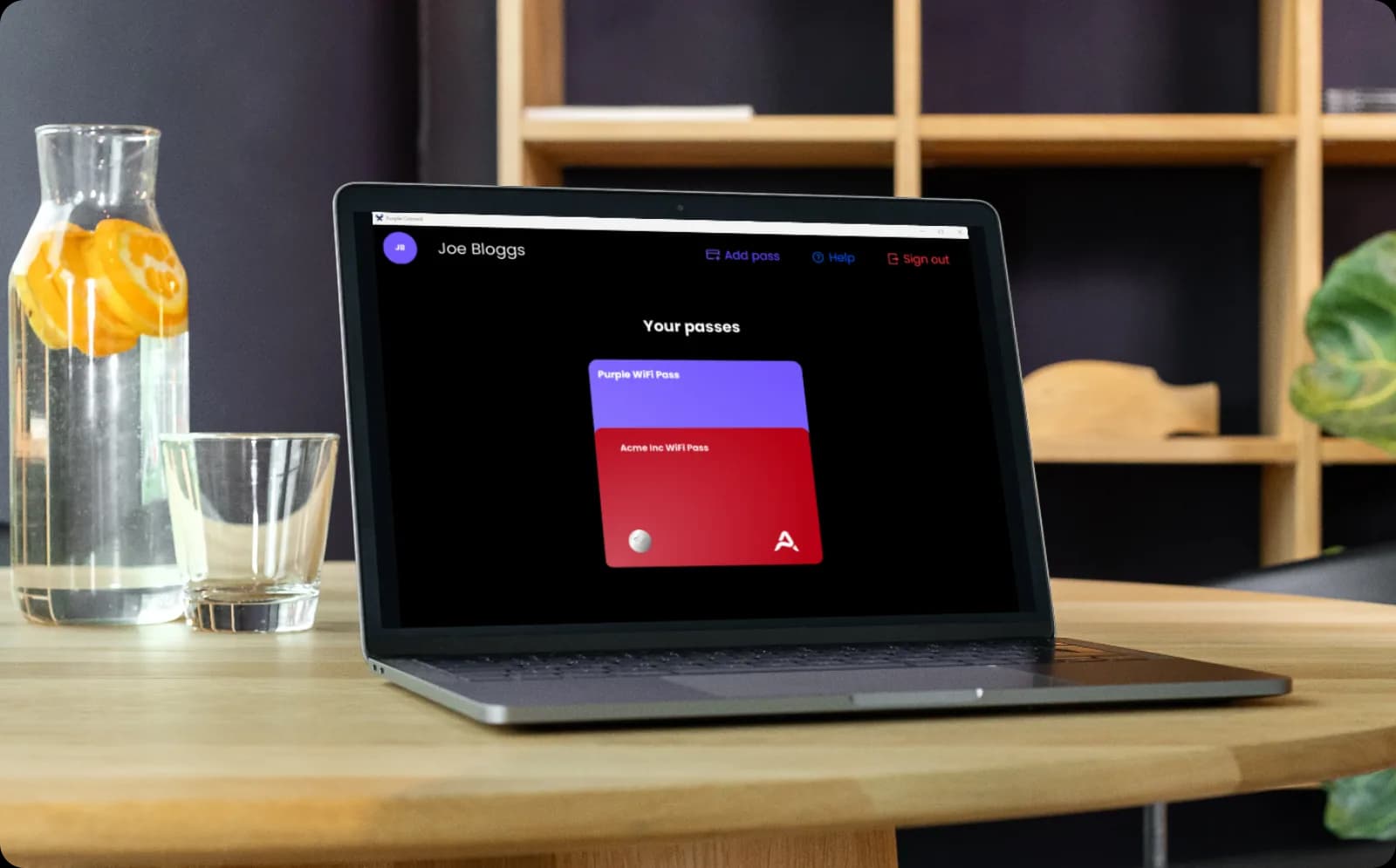 The Purple app on a laptop showing a staff WiFi Pass alongside a company WiFi Pass