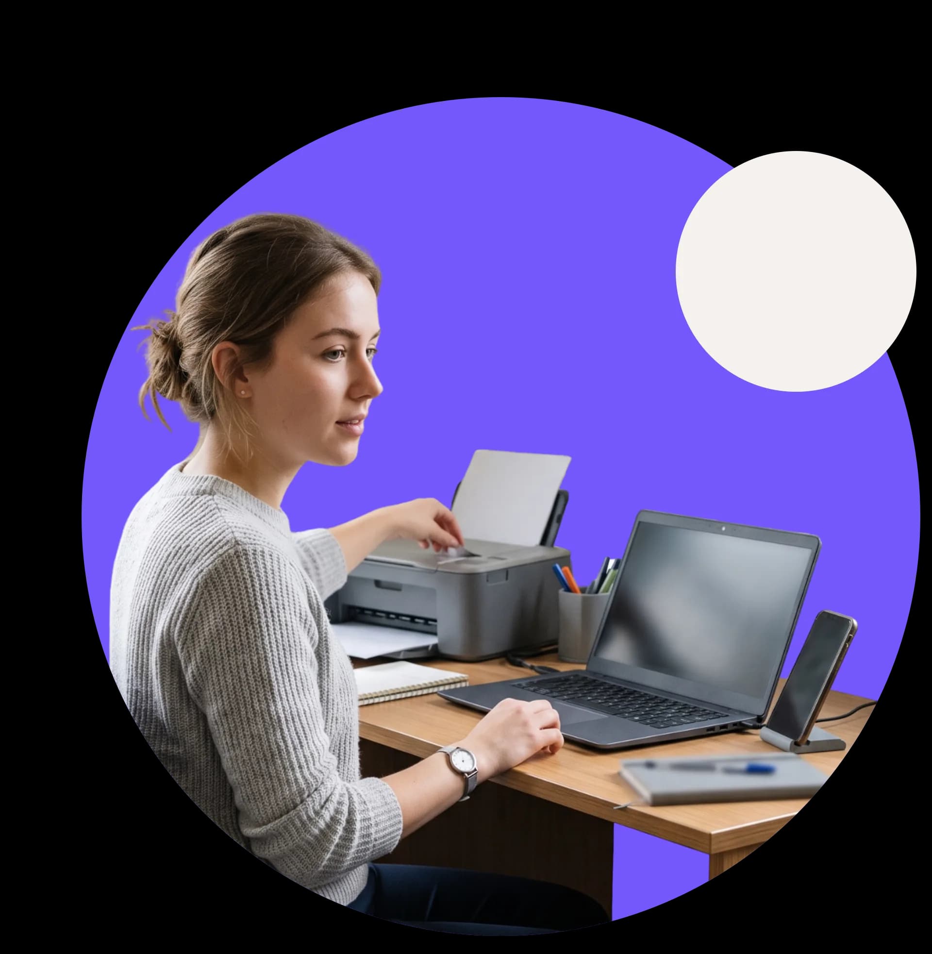 Someone at a desk connecting a printer alongside their laptop and phone, all on one WiFi key
